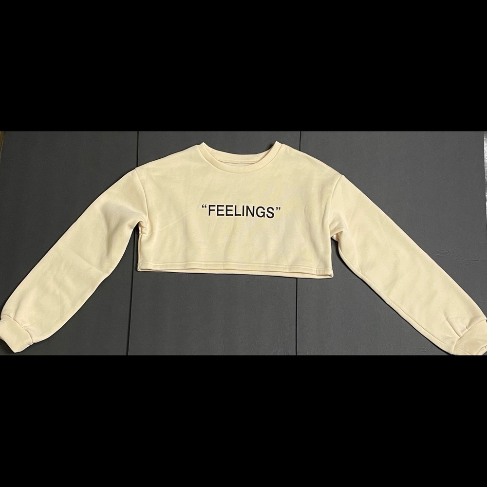 Crop Top. Beige “FEELINGS”. Size Large. Brand New.